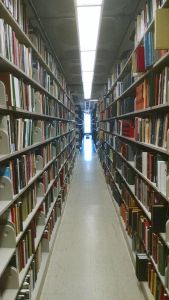 Library stacks. Photo by ndshankar, CC 4.0.